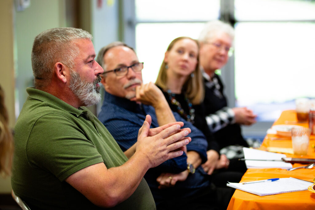 A man shares during a meeting
